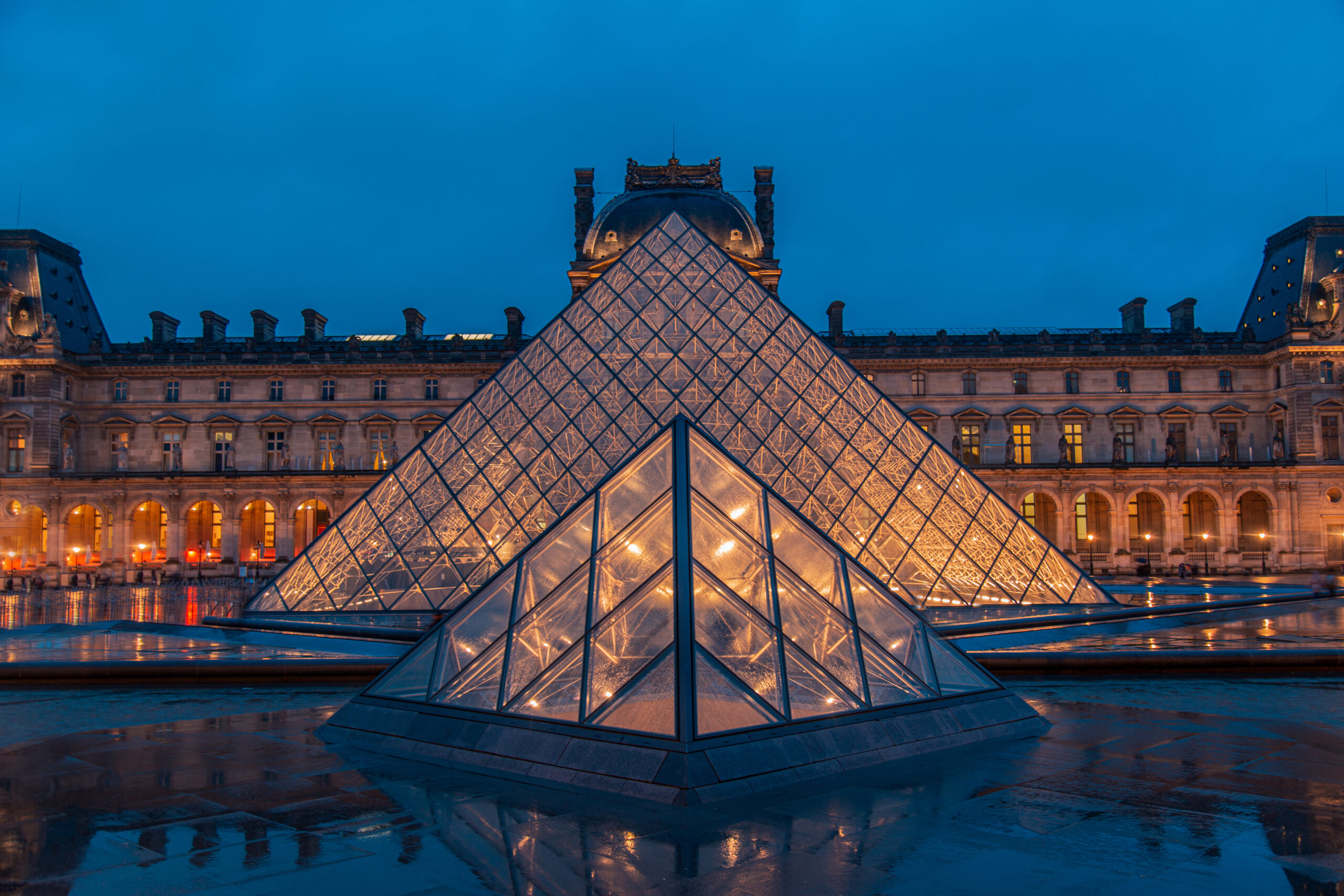 Amazing view from a Louvre Pyramid from a dark and moody day wit Amazing view from a Louvre Pyramid from a dark and moody day with rainy weather.